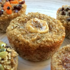 several muffins on a plate with nuts and raisins