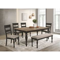 a dining room table with chairs and bench