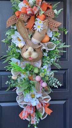 an easter bunny wreath hanging on the front door