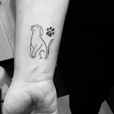 a person with a dog paw tattoo on their wrist