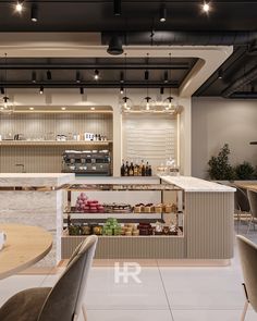 the interior of a restaurant with tables, chairs and shelves filled with condiments