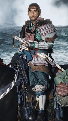 a man dressed in armor riding on the back of a horse next to an ocean