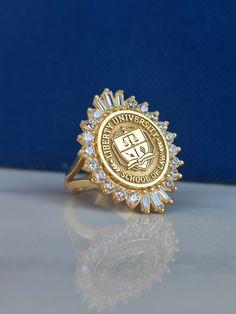 a close up of a gold ring on a white surface with a blue wall in the background