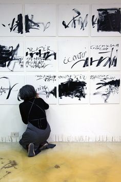 a person kneeling down in front of some art