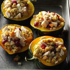 four stuffed bell peppers with stuffing and cranberry sauce on the top are ready to be cooked