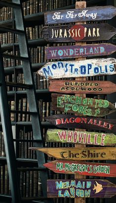 a wooden sign sitting in front of a bookshelf filled with lots of books