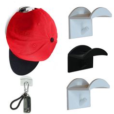 three hats hang from hooks on the wall and one has a hat clip attached to it