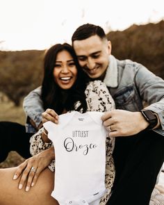 a man and woman holding up a white shirt