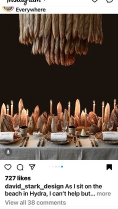 an image of a table with food on it and candles in the middle that are lit