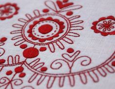 red and white fabric with designs on it