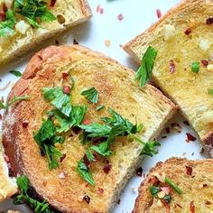 several pieces of bread on a plate with parsley sprinkled on top,