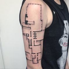 a man's arm with a black and white image of a building on it