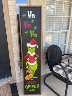 the grinch christmas sign is next to a chair