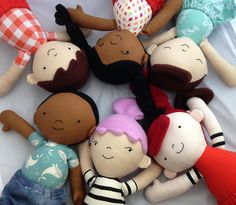 a group of stuffed dolls laying on top of each other