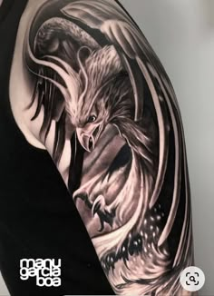 a man's arm with an eagle and wolf tattoo design on the upper half of his arm