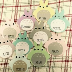 some cute little tags that are sitting on a plaid table cloth with the names of animals