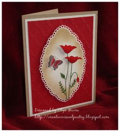 a red and white card with some flowers on the front, and two butterflies on the back