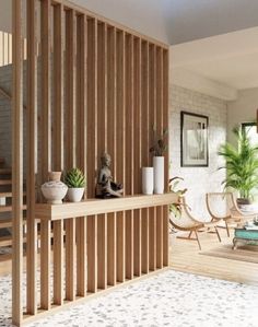 a living room with wooden slats and potted plants on the shelf next to it