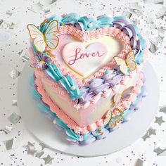 a heart shaped cake with butterflies on it