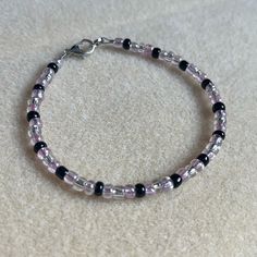 - One Of A Kind Beaded Charm Bracelet - Featuring Clear Translucent, Purple Translucent, And Black Seed Beads - Silver Colored Hardware - Clasps Closed. No Stretch. - Size/ Circumference Is 7.5” - Handmade (By Myself). Perfect To Treat Yourself Or To Give As A Gift! **Add 2 Jewelry Items Marked “2 For $20” To Your Bundle And I Will Send You An Offer For $20** Check Out The “Boutique” Tab In My Closet For Handmade Earrings, Bracelets, And Necklaces! Adjustable Purple Bracelet With Black Beads, Adjustable Purple Bracelets With Black Beads, Purple Beaded Bracelets With Black Beads As A Gift, Purple Beaded Bracelets, Beaded Charm Bracelet, Blue Beaded Bracelets, Black Beaded Bracelets, Purple Beaded, Purple Bracelet