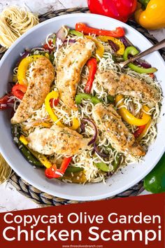 a white bowl filled with chicken scamps and peppers on top of a table