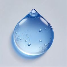 a drop of water that is on top of a white surface with drops of water