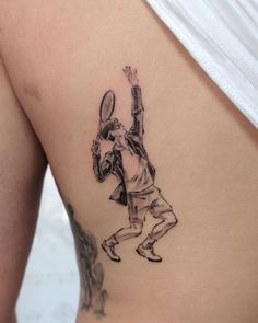 a woman with a tennis racquet tattoo on her side ribcacture