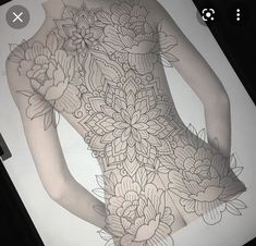 the back of a woman's body with flowers on it