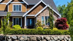 Stunning retaining wall with a beautifully landscaped home Landscaping With Rocks