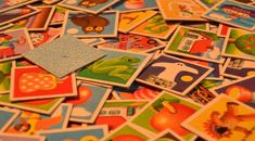 a pile of colorful children's pictures sitting on top of a table