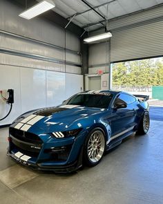 a blue sports car parked in a garage