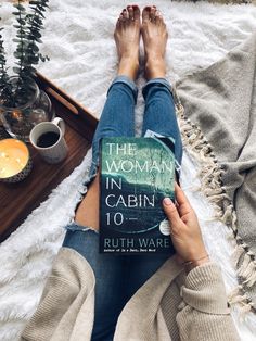 the woman in cabin 10 by ruth waree is sitting on a rug with her legs crossed