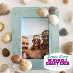 two men and one woman are smiling in front of sea shells on the table with a blue frame