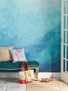 a room with a couch, rug and blue painted wall in the corner next to an open door