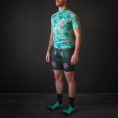 a man in green cycling clothing standing with his hands on his hips