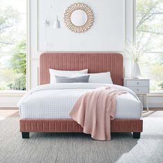 a bedroom with a pink bed and white walls