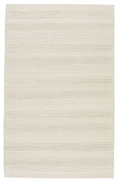 a white rug with wavy lines on the bottom, and one line in the middle