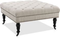 an upholstered foot stool with black legs and nail polishing on the top