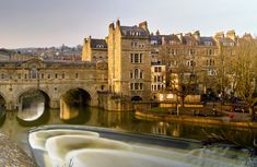 a river running through a city next to tall buildings