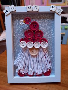 a white frame with red and white buttons in it that says ho ho hoo