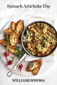 spinach artichoke dip on a plate with bread and radishes next to it