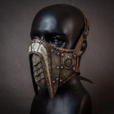 Leather and steel mask. Inside the mask is leather, base is hand-stitched and trimmed with leather at the edges. Metal elements are hand-cut from steel and then shaped using repoussage techniques. The whole is carefully painted, shaded and chemically and mechanically aged.  Adjustable - It ties up with leather buckles.  It will fit more on a male face (due to the size of the mask), but on request I can make a smaller version that will fit a smaller face. The mask is a prop, it is not a real dust Adjustable Post-apocalyptic Mask, Medieval Mask For Larp, Steampunk Masks For Cosplay Events, Steampunk Mask For Cosplay Events, Steampunk Mask For Cosplay, Warrior Style Masks And Prosthetics For Larp And Halloween, Warrior Style Masks And Prosthetics For Halloween, Warrior Style Masks For Cosplay And Masquerade Events, Medieval Mask For Cosplay