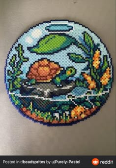 a cross stitch picture of a turtle in the water