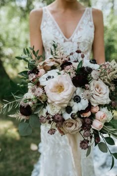 a bride holding a bouquet of flowers in her hands