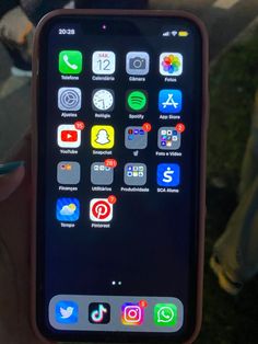 someone holding an iphone in their hand with different icons on the screen and below it