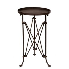 an iron and wood side table with round tray on the top, isolated against a white background