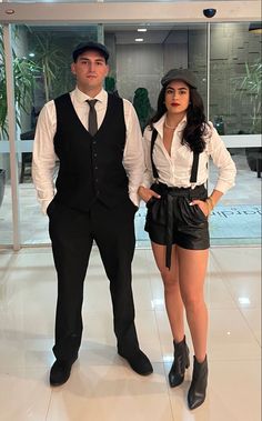 the man and woman are dressed up in formal attire, posing for a photo together