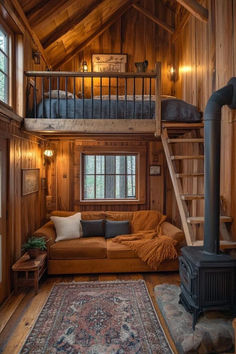 a living room filled with furniture and a fire place in the middle of a loft