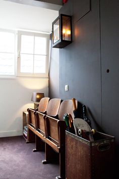 a row of chairs sitting next to each other in front of a window on a wall