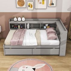 a bedroom with a bed, dresser and pictures on the wall above it that has a pink rug in front of it